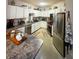 Well-lit kitchen boasts granite countertops, stainless steel appliances, and bright white cabinetry at 911 N Orange Ave # 142, Orlando, FL 32801