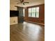 Cozy living room featuring wood-look floors, a barn door, and natural light from the windows at 911 N Orange Ave # 142, Orlando, FL 32801