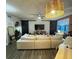 Spacious living room with a large white sectional, barn doors, and modern decor at 911 N Orange Ave # 142, Orlando, FL 32801