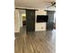 Open-concept living room featuring wood-look floors, barn doors, and an entertainment area at 911 N Orange Ave # 142, Orlando, FL 32801