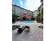 Beautiful community pool surrounded by chairs and lush landscaping at 911 N Orange Ave # 142, Orlando, FL 32801