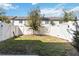 A fenced backyard with a tree in the middle and new grass seed makes it perfect for enjoying outdoors at 916 Grandin St, Davenport, FL 33837