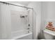 A full bathroom shows a white tiled shower with a toilet and vanity at 916 Grandin St, Davenport, FL 33837