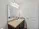 This bathroom features a large vanity, mirror, lighting fixture and a view to a bedroom at 916 Grandin St, Davenport, FL 33837