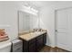 Bathroom with a vanity with granite countertops, modern lighting and wood-look floors at 916 Grandin St, Davenport, FL 33837