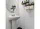 This half-bathroom features a modern sink with decorative shelving at 916 Grandin St, Davenport, FL 33837