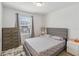 This bedroom features a window, dresser, lamp, and a patterned duvet set at 916 Grandin St, Davenport, FL 33837