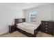This bedroom features neutral colored walls, a window, and dark furniture set at 916 Grandin St, Davenport, FL 33837