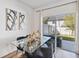 Dining room boasts a glass table, dark chairs, and access to a patio and backyard at 916 Grandin St, Davenport, FL 33837
