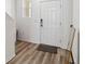 Bright foyer with wood-look flooring and a white front door at 916 Grandin St, Davenport, FL 33837