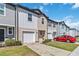 Charming townhomes with individual garages, manicured lawns, and modern design at 916 Grandin St, Davenport, FL 33837