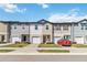 Charming townhomes with individual garages, manicured lawns, and modern design at 916 Grandin St, Davenport, FL 33837