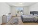 Comfortable bedroom with plush carpeting, stylish grey furniture, and great natural light at 916 Grandin St, Davenport, FL 33837