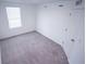 Bright bedroom with a large window and neutral carpeting, with a closed door on the right at 947 Conch Rd, Davenport, FL 33896