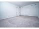 Large carpeted bedroom featuring neutral colored walls and two doors providing access at 947 Conch Rd, Davenport, FL 33896