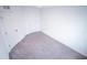 Bedroom featuring neutral carpeting and white walls with two doors at 947 Conch Rd, Davenport, FL 33896