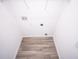 A clean and well lit closet with neutral wood flooring and installed shelving at 947 Conch Rd, Davenport, FL 33896