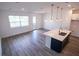 Stylish open floorplan with bright kitchen, an island with a sink, and modern pendant lighting at 947 Conch Rd, Davenport, FL 33896