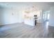 Bright, open-concept kitchen features white cabinets, stainless steel appliances, and a large island at 947 Conch Rd, Davenport, FL 33896