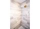 Close up of a luxurious shower with elegant tilework and modern fixtures at 947 Conch Rd, Davenport, FL 33896