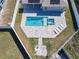 Aerial view of backyard pool and spa area surrounded by a white fence and green space at 152 Big Black Dr, Kissimmee, FL 34759