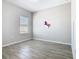 Bright bedroom with wood-look floors featuring a colorful unicorn wall decoration at 152 Big Black Dr, Kissimmee, FL 34759