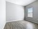 Well-lit bedroom with wood-look floors and a window that allows natural light at 152 Big Black Dr, Kissimmee, FL 34759