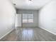 Bedroom with wood-style flooring, gray walls, a window with blinds, and a door at 152 Big Black Dr, Kissimmee, FL 34759