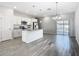 Modern kitchen featuring stainless steel appliances, granite countertops, white cabinets, a kitchen island, and sliding glass doors at 152 Big Black Dr, Kissimmee, FL 34759
