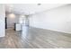 A spacious living room features gray walls, gray wood-style flooring, and recessed lighting at 152 Big Black Dr, Kissimmee, FL 34759