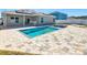 Backyard pool with outdoor kitchen featuring custom stonework and an adjacent outdoor seating area at 152 Big Black Dr, Kissimmee, FL 34759