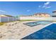 Backyard pool and spa with lounge chairs, surrounded by a white fence and blue skies at 152 Big Black Dr, Kissimmee, FL 34759