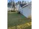 Large backyard with a lush green lawn and privacy landscaping at 11115 Sw 54Th Cir, Ocala, FL 34476