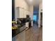 Modern kitchen with white cabinets, stainless steel appliances, and dark countertops at 11115 Sw 54Th Cir, Ocala, FL 34476