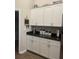 Bright kitchen featuring ample white cabinetry and dark countertops at 11115 Sw 54Th Cir, Ocala, FL 34476