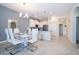 Bright dining area featuring a modern white table set and contemporary chandelier near the kitchen with stainless appliances at 1137 Drop Ln # 1137, Davenport, FL 33896