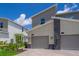 Modern home exterior showcasing clean lines, neutral colors, and attached garages with a well-maintained front yard at 1137 Drop Ln # 1137, Davenport, FL 33896