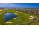 Aerial view of a golf course with a lake and residential housing in the background at 1137 Drop Ln # 1137, Davenport, FL 33896