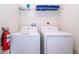 Functional laundry room equipped with a washer, dryer, and storage shelving at 1137 Drop Ln # 1137, Davenport, FL 33896