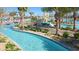 A relaxing lazy river with clear blue water, palm trees, and lush landscaping at 1137 Drop Ln # 1137, Davenport, FL 33896