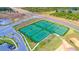 Aerial view of six fenced, well-maintained tennis courts with parking and sidewalks at 1137 Drop Ln # 1137, Davenport, FL 33896