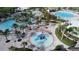 Aerial view of a community water park with pools, splash pad, and lounge chairs at 1137 Drop Ln # 1137, Davenport, FL 33896