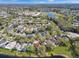 Expansive overhead image of a peaceful residential area with tree-lined streets, serene lakes, and well-spaced houses at 13223 Meadowlark Ln, Orlando, FL 32828