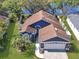 Inviting property with a manicured lawn, palm trees, and scenic views of the lake at 13223 Meadowlark Ln, Orlando, FL 32828