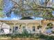 Back of the home featuring a covered patio with seating, decorative details, and a lovely yard at 13223 Meadowlark Ln, Orlando, FL 32828