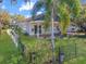 Cozy outdoor space featuring a charming patio, lush greenery, and a black iron fence, perfect for relaxing at 13223 Meadowlark Ln, Orlando, FL 32828