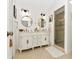Bathroom featuring a double vanity with gold framed mirrors and a glass enclosed shower at 13223 Meadowlark Ln, Orlando, FL 32828