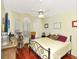 Bedroom with natural light, and a dark wood floor, ceiling fan and a large window at 13223 Meadowlark Ln, Orlando, FL 32828