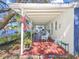 Charming covered patio with red brick flooring and an outdoor seating area overlooking the water at 13223 Meadowlark Ln, Orlando, FL 32828