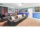 Spacious finished basement with a large sectional sofa and movie posters at 1432 Rolling Fairway Dr, Davenport, FL 33896
